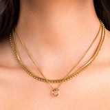 Nina Layered Circle Charm Necklace by ARIIRA featuring gold-plated chains and polished circle charm, symbolizing unity.