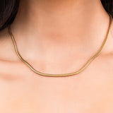 Elegant Alina Gold Herringbone Necklace worn, featuring smooth gold-plated stainless steel with a refined design.