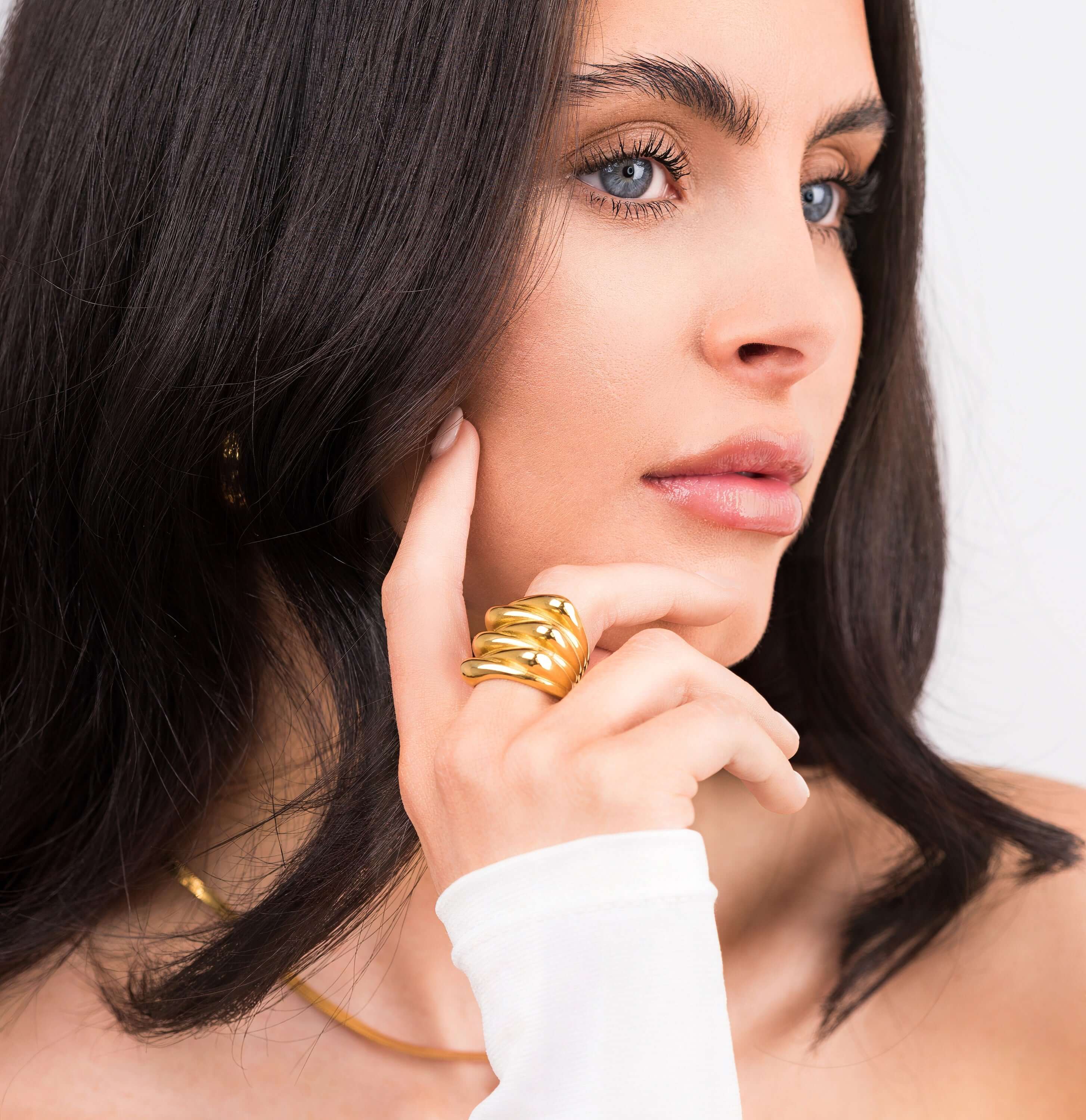 Model showcasing the Alina Gold Sculpted Statement Ring, featuring smooth ridges and a bold, elegant design.