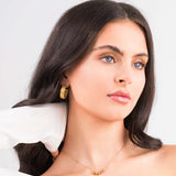 Model wears Noura Gold Beaded Detail Necklace with elegant simplicity and soft structure, highlighting the delicate golden beads.