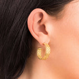 Lyra Gold Textured Hoop Earrings worn on ear, showcasing intricate woven design and modern elegance by ARIIRA.