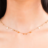 Delicate Isla Gold Circle Drop Necklace in gold-plated stainless steel, featuring polished discs on a fine chain.