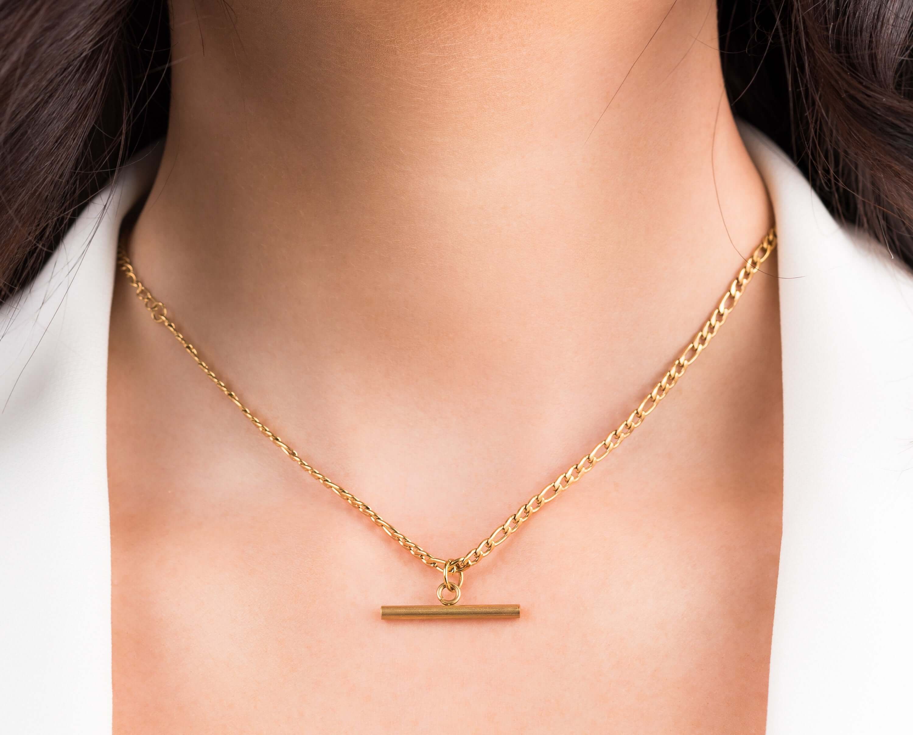 Mila Gold Bar Pendant Necklace by ARIIRA featuring a polished gold bar charm on a stylish chain.