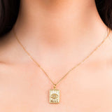 Lana Gold Angel Eye Pendant Necklace by ARIIRA, featuring a textured rectangular charm and sparkling diamante detail.