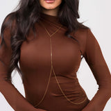 Athena Minimal Gold Body Chain by ARIIRA, featuring Y-shaped silhouette and bar details, worn over a brown top.