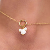 Close-up of a delicate gold-plated anklet featuring pearl-like charms, showcasing elegance and femininity.