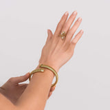 Model wearing a Lyra Crystal Branch Adjustable Ring and a gold bracelet, showcasing elegant jewelry styling.