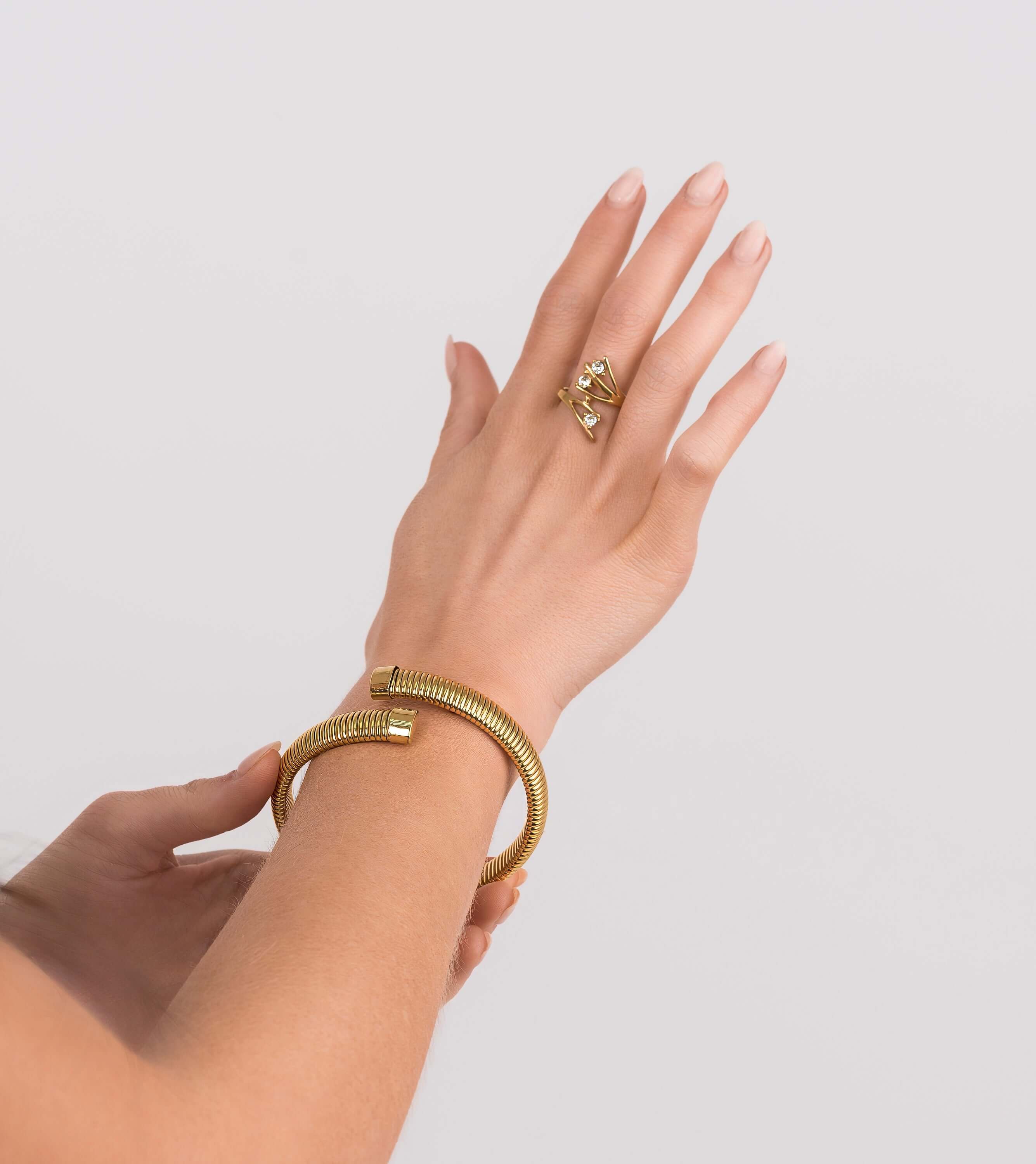 Model wearing a Lyra Crystal Branch Adjustable Ring and a gold bracelet, showcasing elegant jewelry styling.