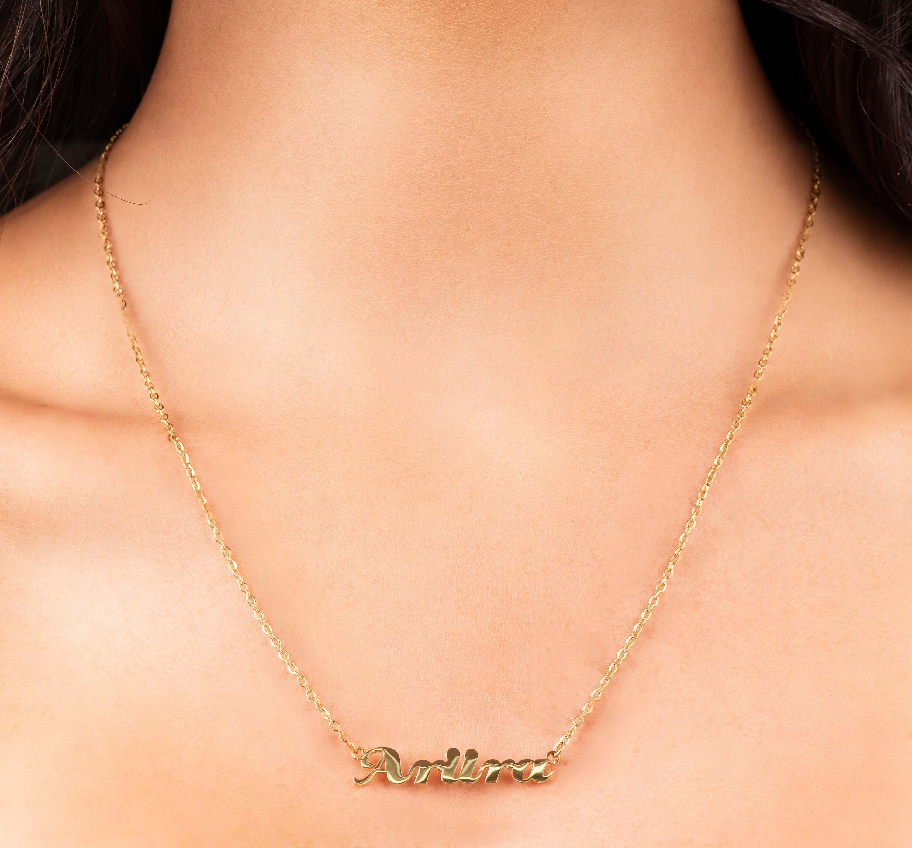 Elegant Alina Cursive Custom Name Necklace featuring 'ARIIRA' in gold cursive on a delicate chain.