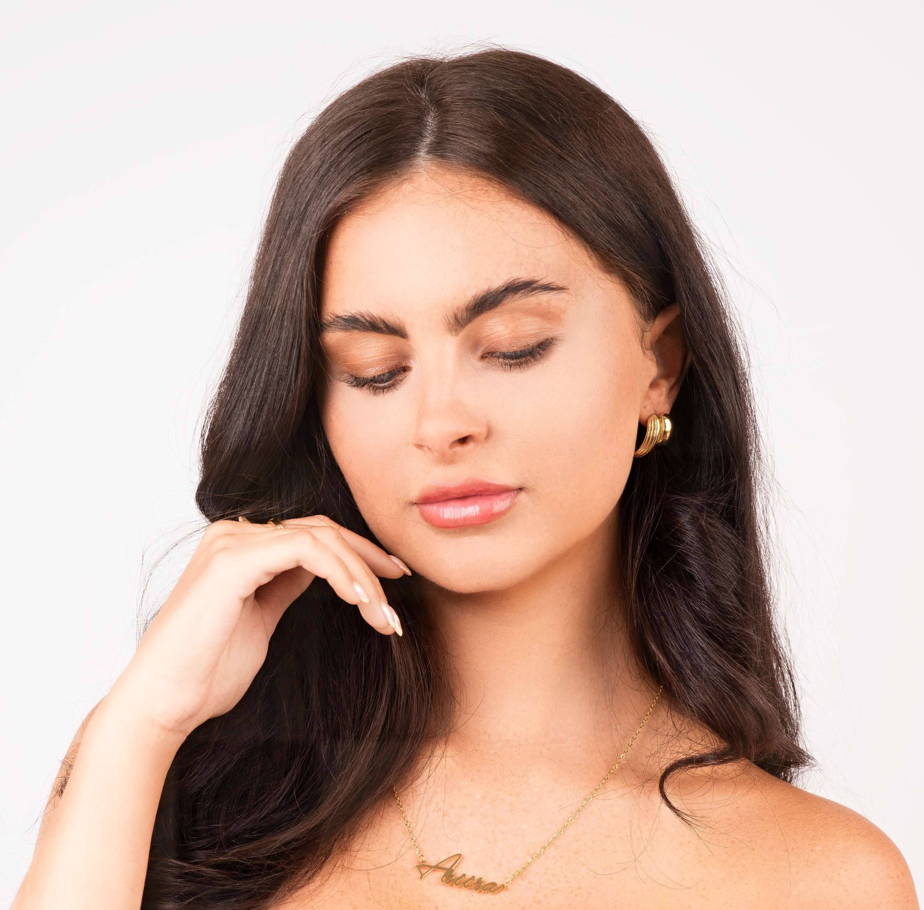 Woman wearing Nura Signature Custom Name Necklace with the name 'ARIIRA', showcasing elegant jewellery style.