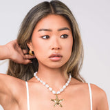 Eden Pearl Bead Necklace with ARIIRA starfish pendant, featuring organic pearls and hammered gold starfish for coastal style.