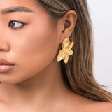 Flora Textured Bloom Stud Earrings by ARIIRA, featuring layered gold petals, capturing elegance and natural beauty.