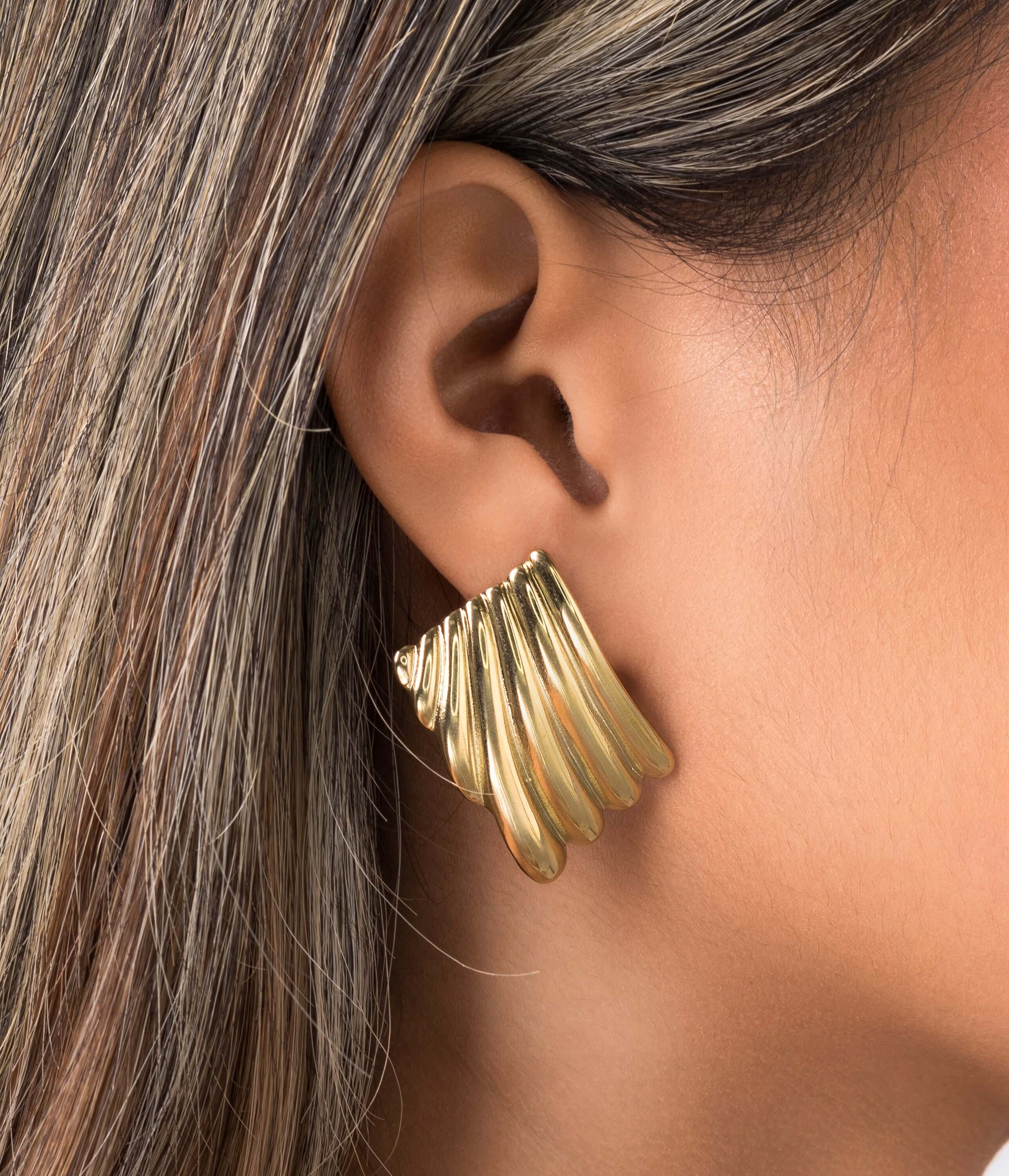 Gold Freya Sculpted Wave Hoops by ARIIRA, showcasing rhythmic ridged design in elegant silhouette.