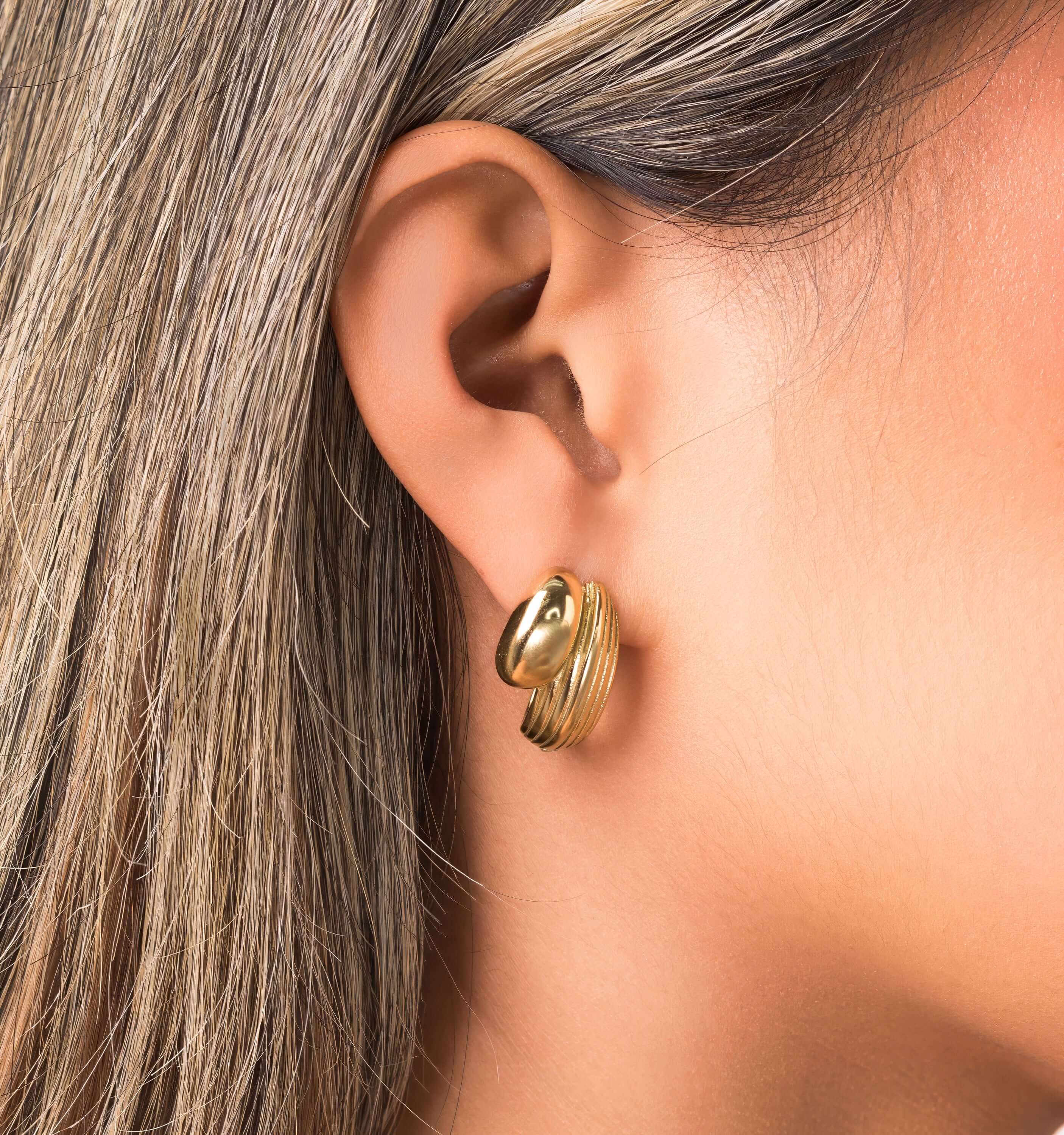 Ayla Textured Curve Hoop Earrings by ARIIRA, showcasing a polished and detailed dual finish in gold.