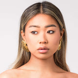 Leila Radiant Sunburst Earrings by ARIIRA showcasing bold gold tone design and sculptural form, perfect for elegant everyday wear.