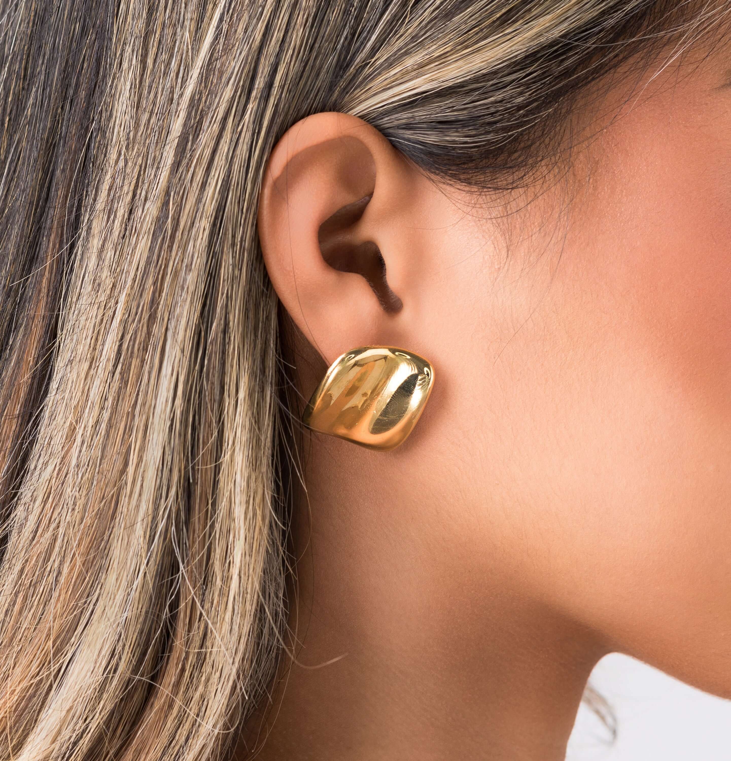 Lara Organic Drop Studs earrings by ARIIRA, showcasing a modern sculpted design with a polished golden surface.