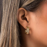 Close-up of a model wearing ARIIRA Dalia Crystal Lattice Hoop Earrings, showcasing their gold latticework and crystals.