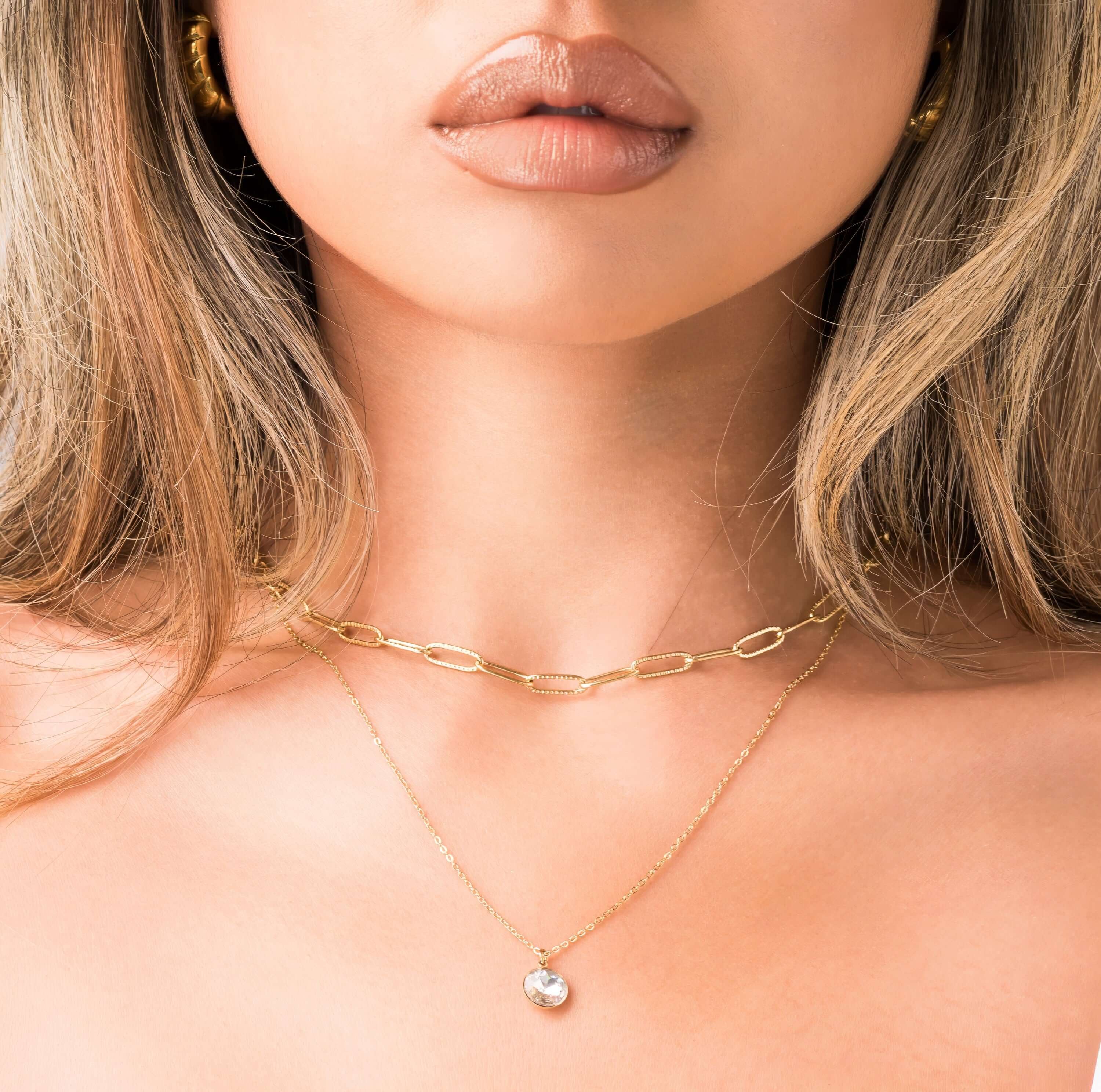 Leonora Layered Chain Necklace by ARIIRA featuring a solitaire charm and a delicate, radiant design.