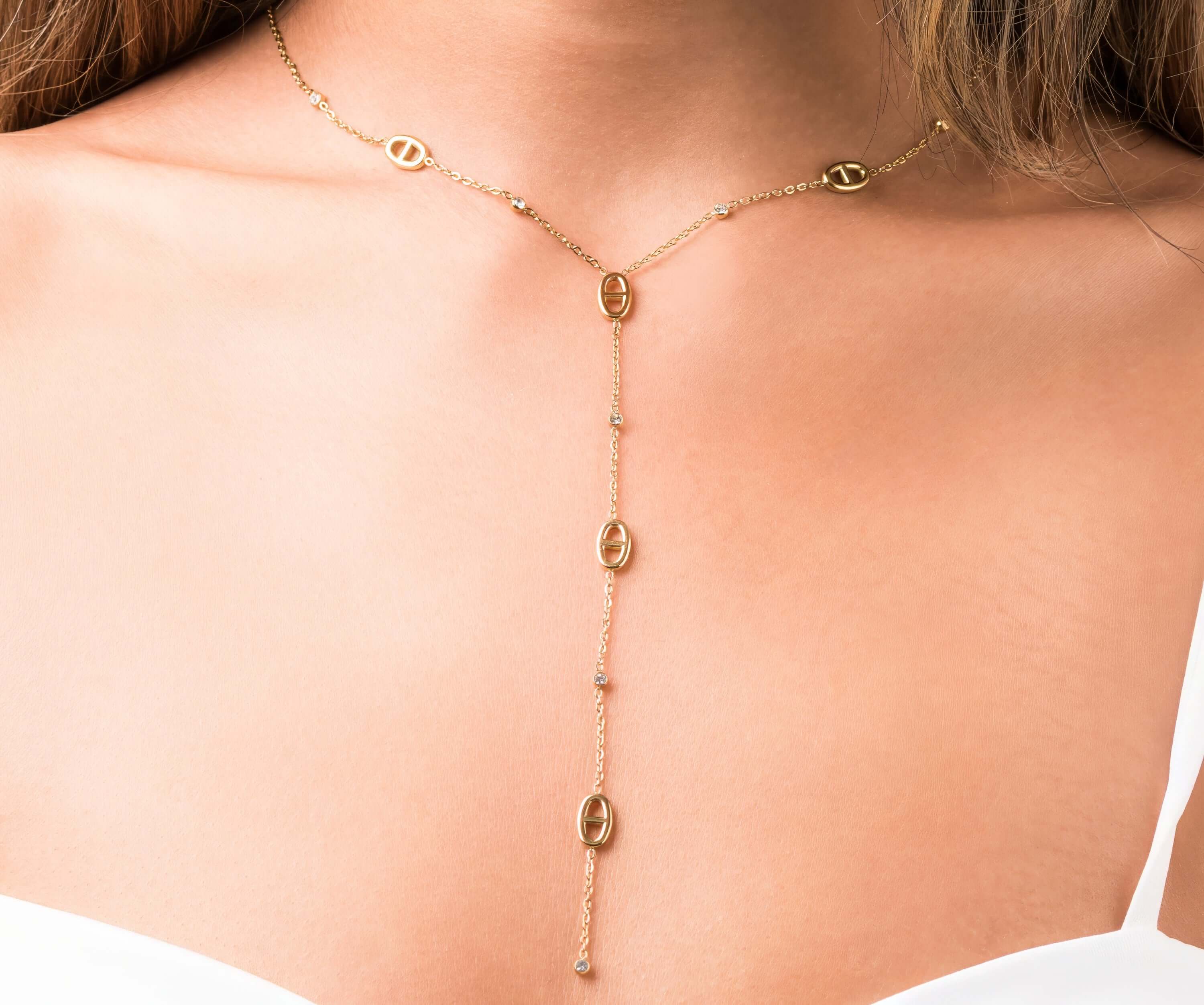 Mireya Y Drop chain necklace with oval motifs by ARIIRA, featuring delicate gold links and sparkling stones.
