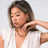 Model wearing the ARIIRA Sandra Oval Link Statement Chain Necklace, showcasing its modern elegance and bold design.