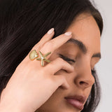 Close-up of a woman wearing the ARIIRA Mira Starfish and Shell Pearl Ring, showcasing its ocean-inspired design.