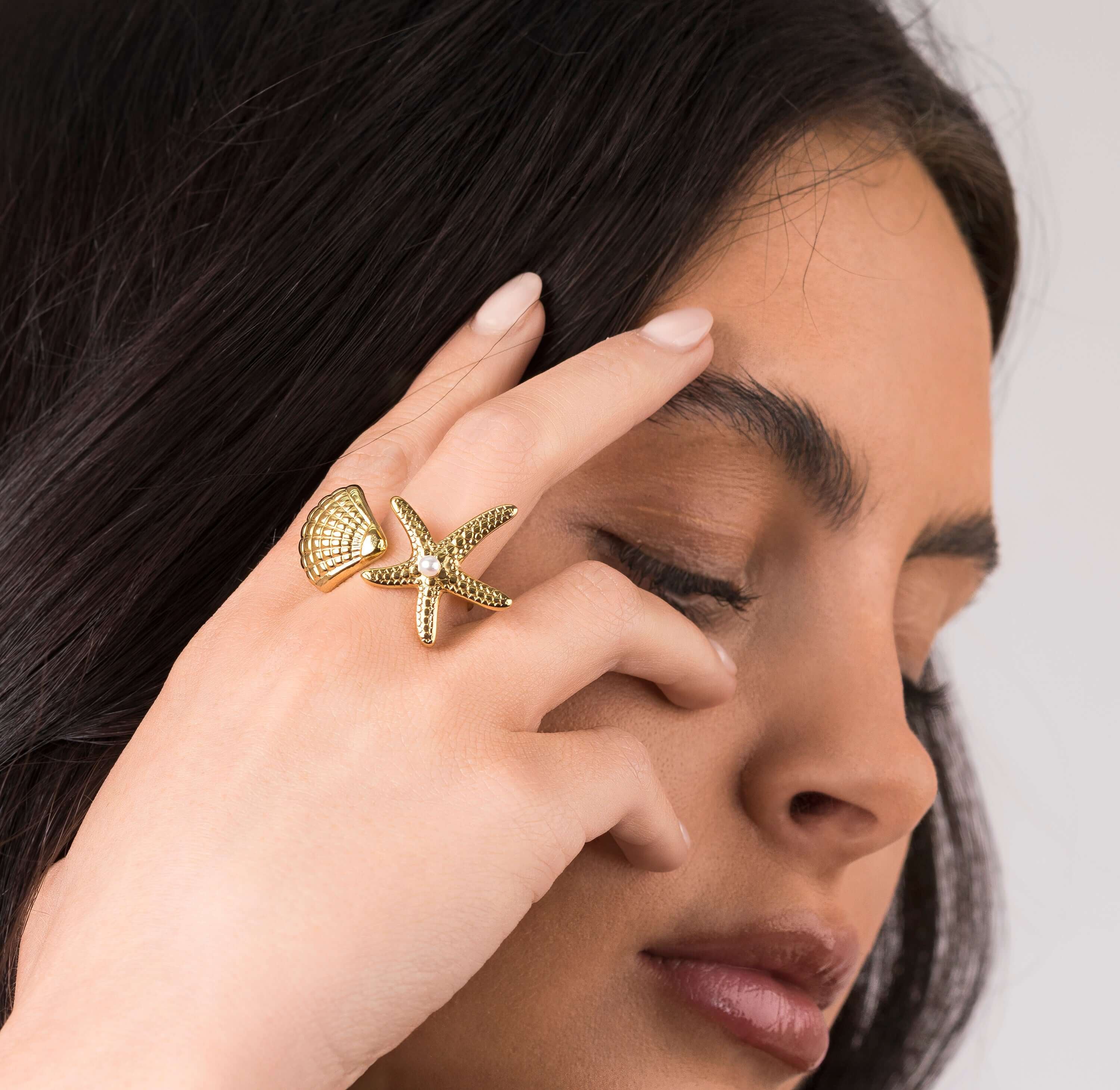 Close-up of a woman wearing the ARIIRA Mira Starfish and Shell Pearl Ring, showcasing its ocean-inspired design.