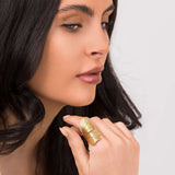 Elegant woman wearing ARIIRA's Aria winged textured adjustable ring, showcasing its delicate gold design.