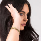 Nahla Wide Link Structured Gold Bracelet by ARIIRA showcased on a model, highlighting its architectural design and shine.