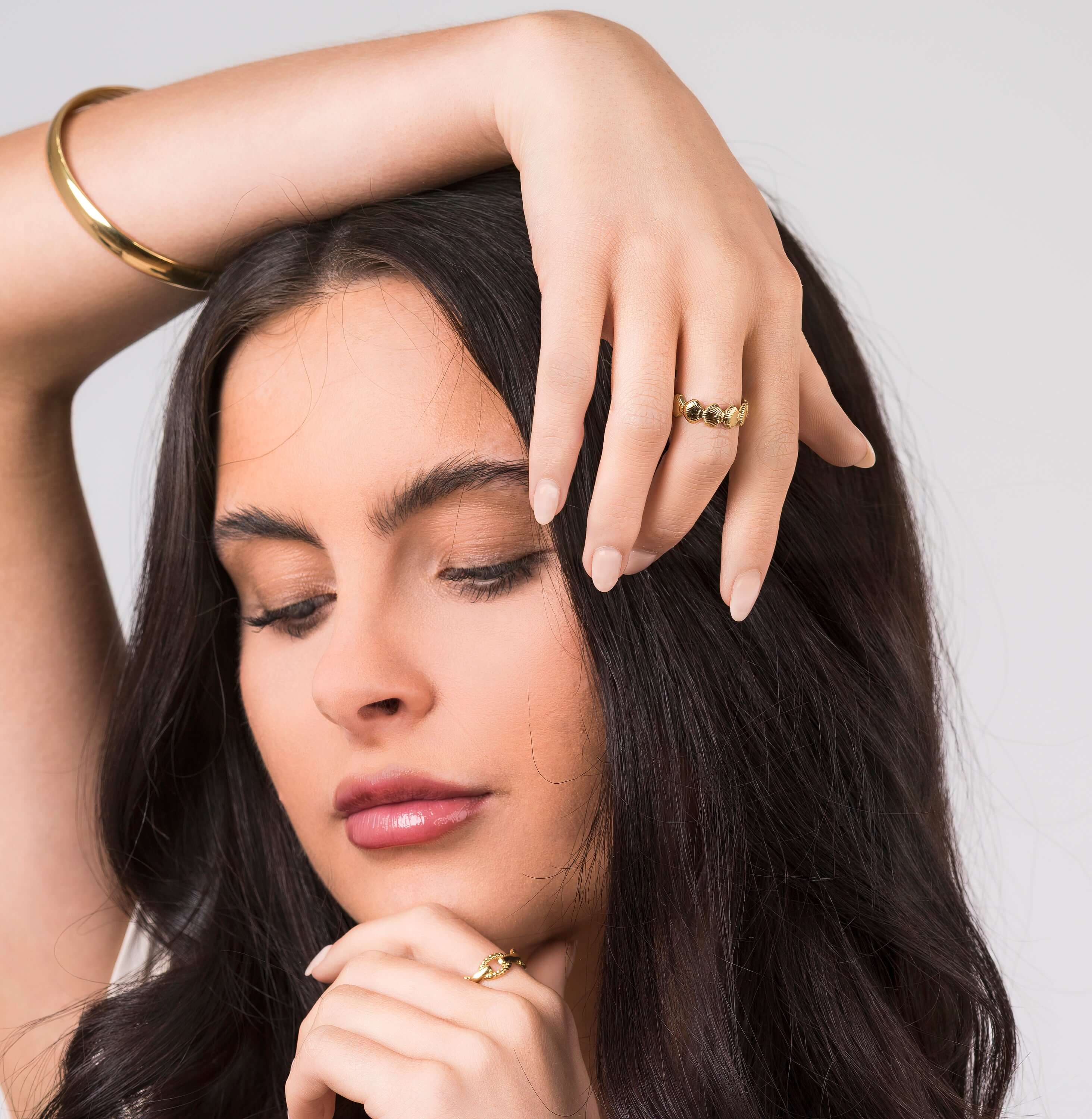 Model wearing ARIIRA Alina Textured Shell Gold Ring, showcasing its elegant design and adjustable fit.