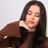 Model showcasing the Naya Monstera Leaf Statement Ring, featuring a sculptural design and elegant gold finish.