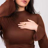 Woman wearing the Agnes Water Drop Adjustable Ring by ARIIRA, showcasing its elegant design on her hand.