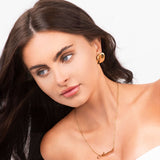 Gold personalised script necklace featuring the name Ariira, worn elegantly by a model with flowing hair.