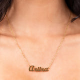 Personalised gold name necklace reading 'Ariira' in bold cursive, a delicate custom jewellery piece.