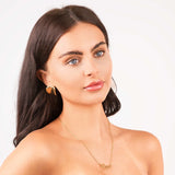 Gold Amira Custom Name Necklace with name ARIIRA worn by a model, showcasing personal style and elegance.