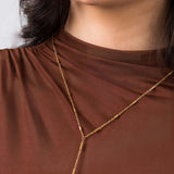 Close-up of a model wearing the Athena Minimal Gold Body Chain with bar details, showcasing its elegant Y-shaped silhouette.