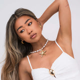 Eden Pearl Bead Necklace with ARIIRA starfish pendant, showcasing organic pearls and gold design, perfect for coastal styling.