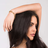 Yasna Mixed Link Gold Bracelet with statement clasp worn by a woman, showcasing its bold design and sculptural texture.