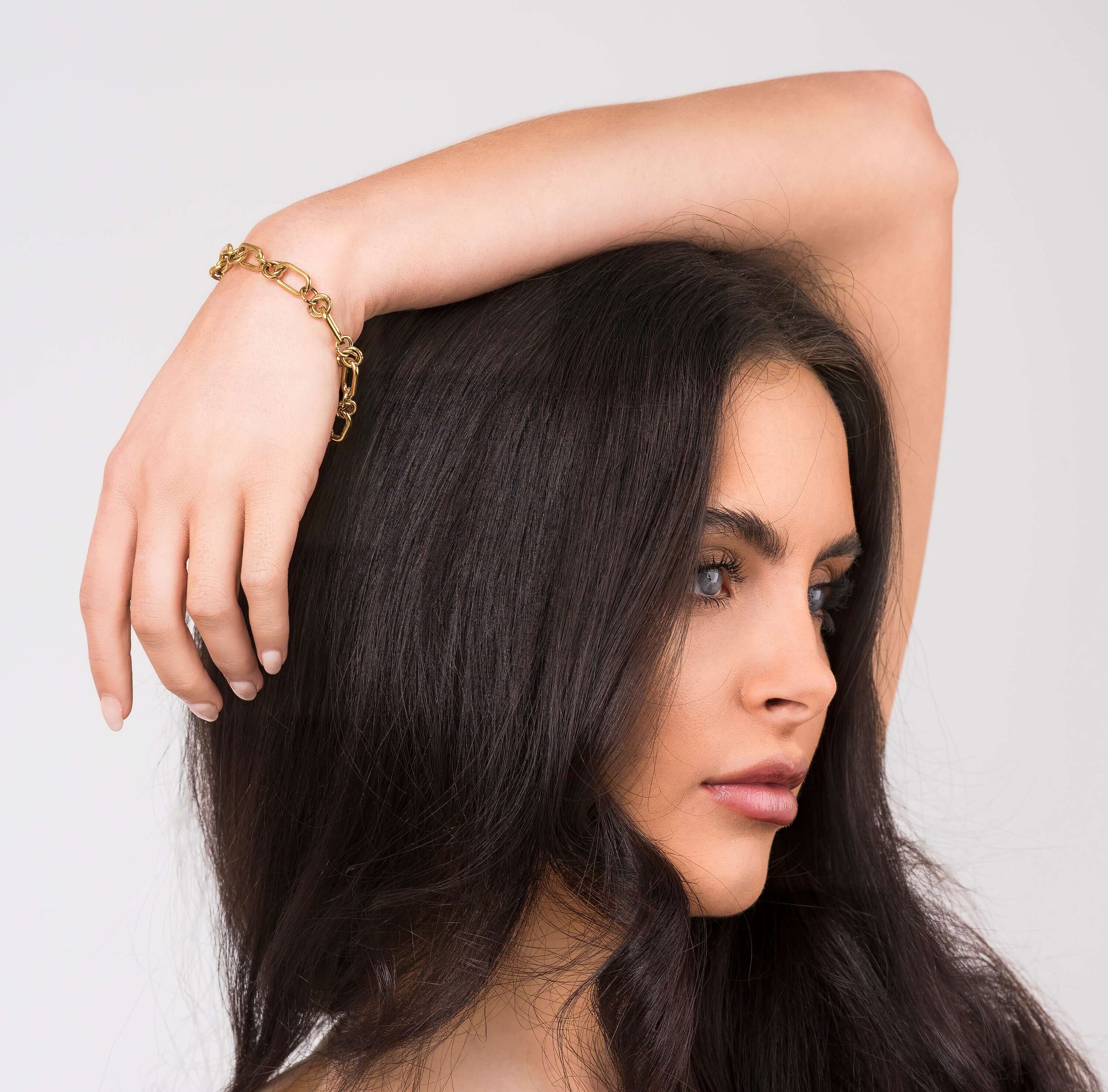 Yasna Mixed Link Gold Bracelet with statement clasp worn by a woman, showcasing its bold design and sculptural texture.
