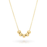 Noura Gold Beaded Detail Necklace featuring five smooth, rounded gold beads on a delicate gold-plated chain.
