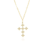 Yasira Crystal Cross Pendant Necklace from ARIIRA featuring a gold chain with light-reflecting stones.