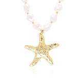 Eden Pearl Bead Necklace with Hammered Gold Starfish Pendant, featuring organic pearl beads for a coastal-inspired look.
