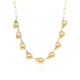 ARIIRA Sculpted Teardrop Link Gold Necklace with fluid, organic teardrop shapes reflecting light elegantly.