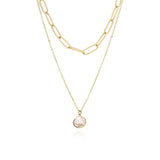 Layered gold chain necklace with solitaire charm by ARIIRA, featuring a light-catching stone for everyday elegance.