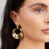 Close-up of a woman wearing Noor Gold Textured Statement Earrings by ARIIRA showcasing their sculptural design and elegant shine.