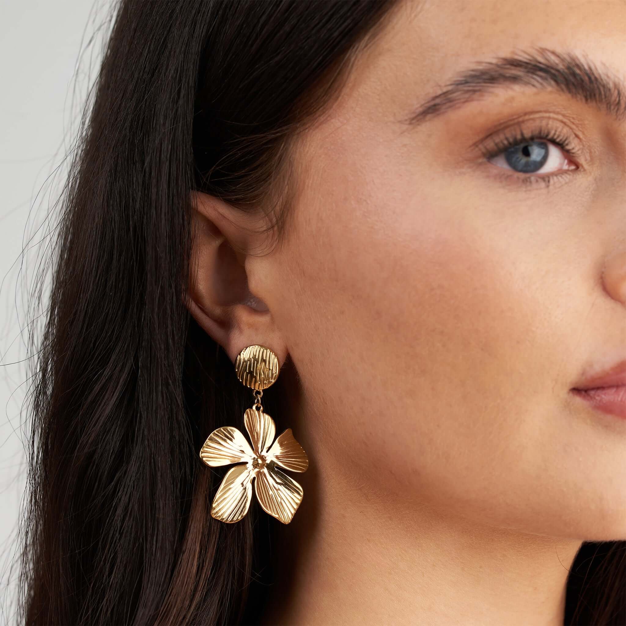 Malia Bloom Statement Earrings by ARIIRA in gold, showcasing textured petals for an elegant look.