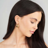 Model showcasing ARIIRA Alina Chunky Gold Hoop Earrings, featuring a polished gold-plated finish for stylish elegance.