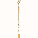 Sleek gold body chain with bar details from ARIIRA, featuring a Y-shaped silhouette and delicate cylindrical elements.