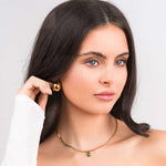 Model wearing ARIIRA Emerald Green Gemstone Necklace in gold, showcasing elegance and modern minimalism.