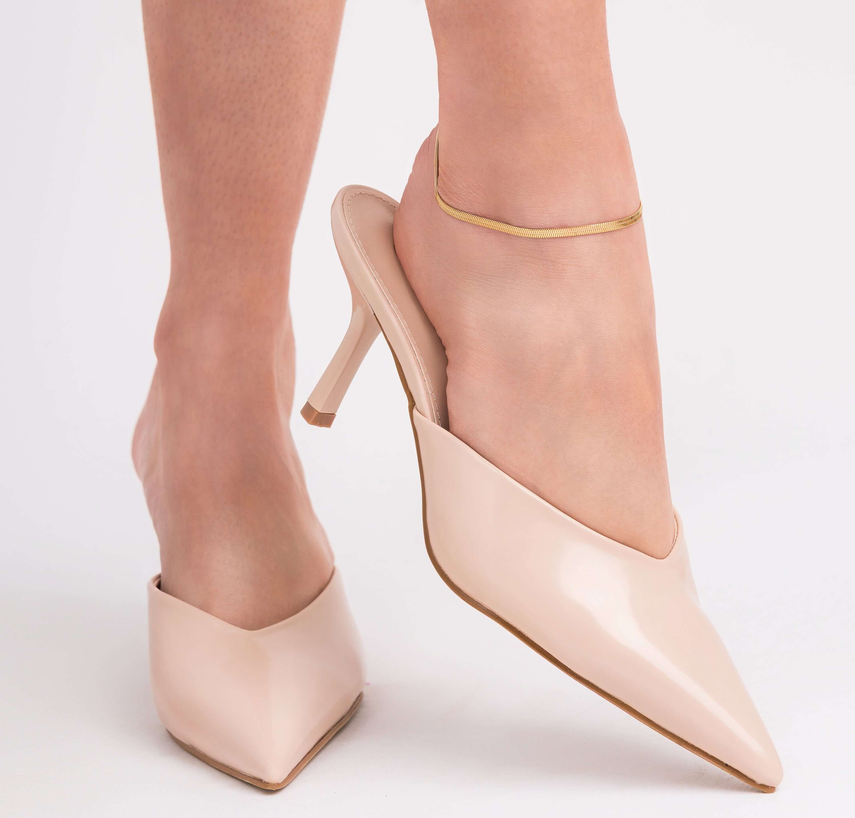 Woman wearing beige pointed heels with Layla Gold Herringbone Anklet for a stylish summer look.