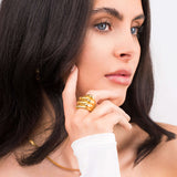 Model showcasing the Alina Gold Sculpted Statement Ring, featuring smooth ridges and a bold, elegant design.